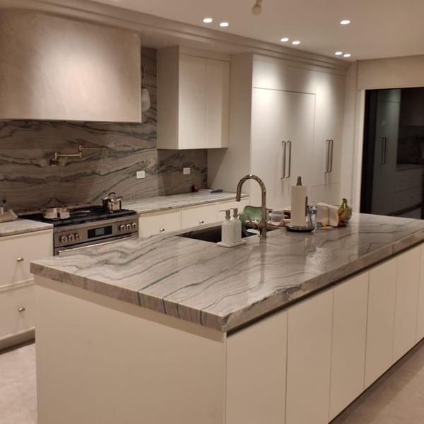 White kitchen with grey marble island by CABINX
